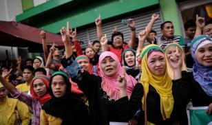 Filipino Muslim women celebrate during a peace gathering at a mosque in Manila, Philippines